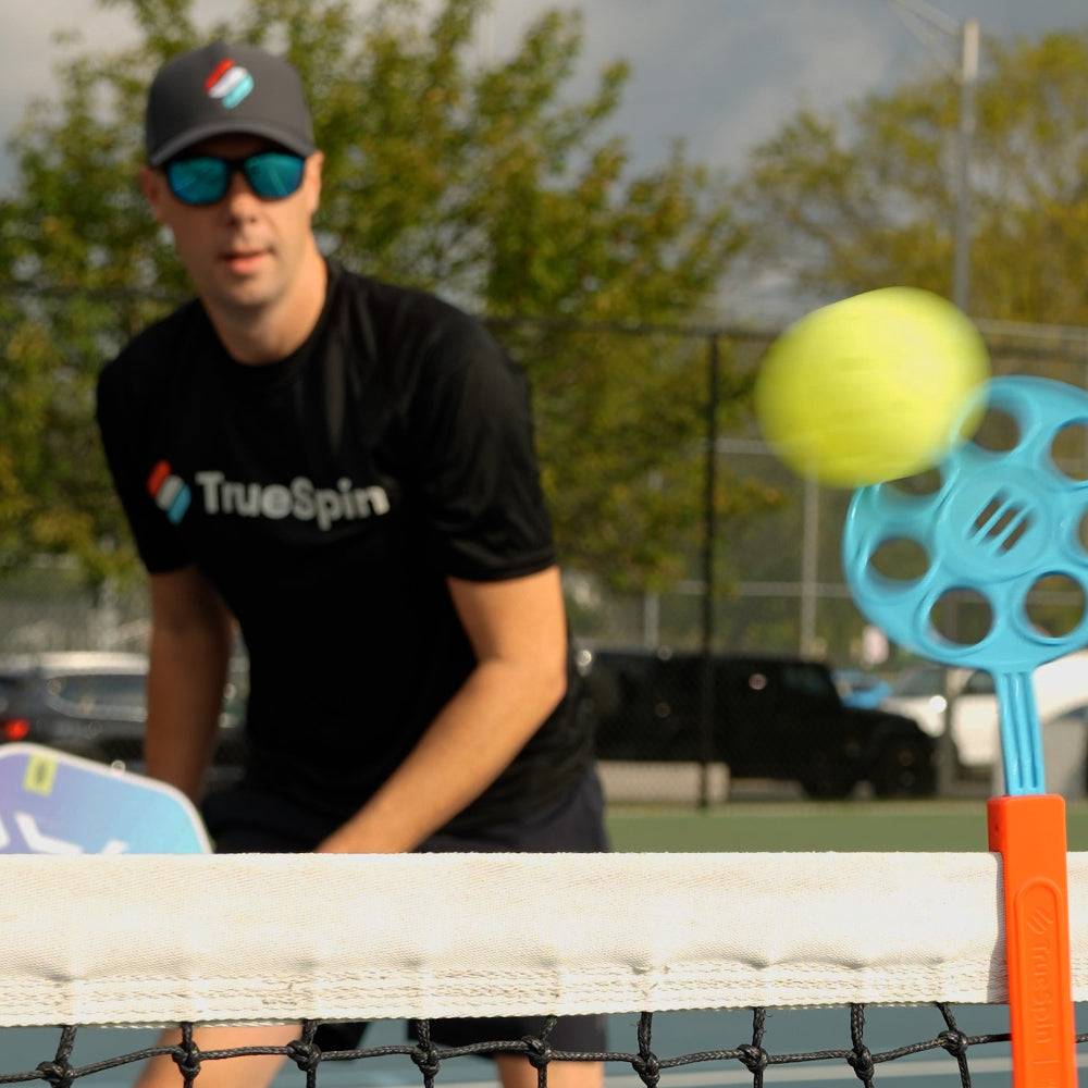 pickleball coach using a training aid to practice