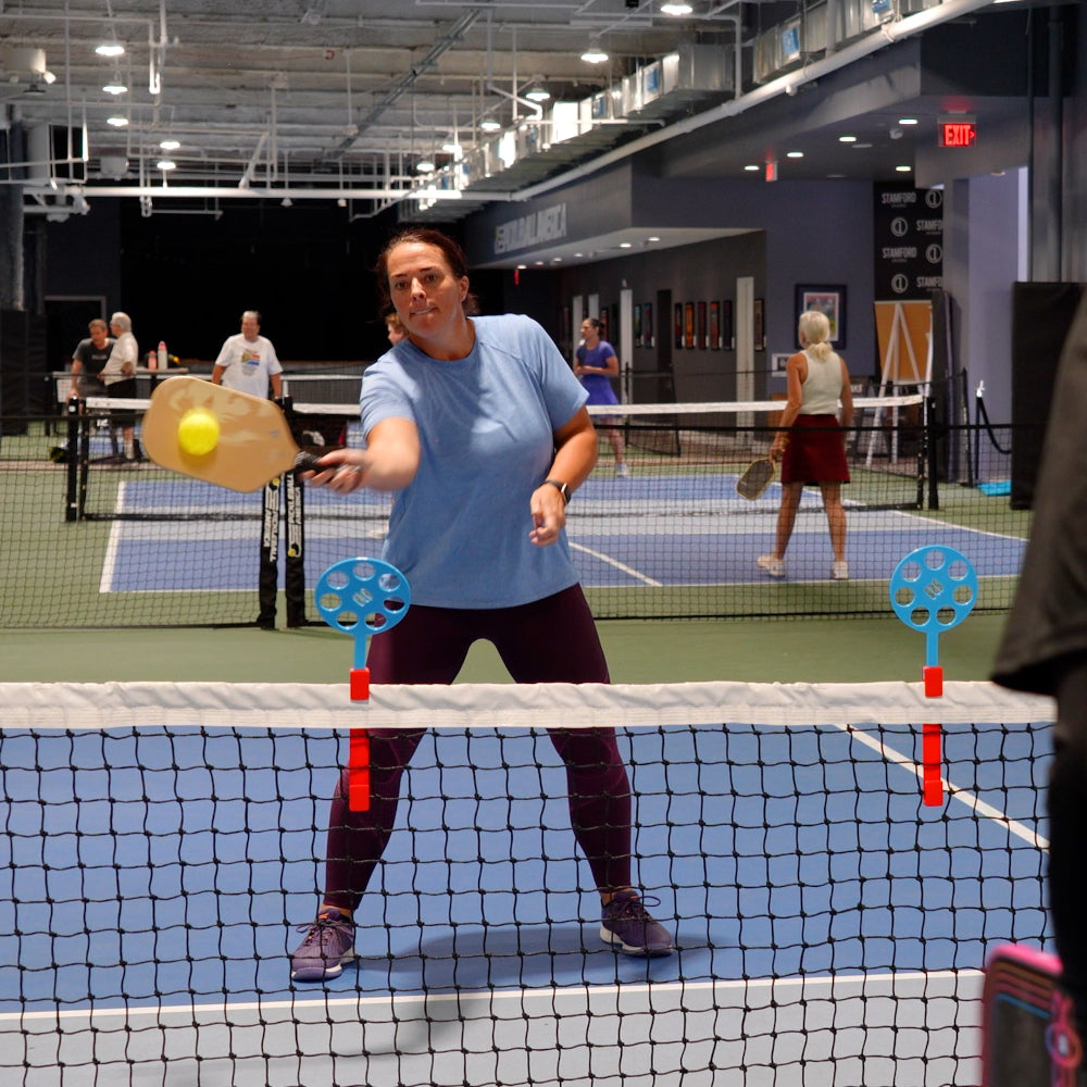 pickleball player using a net top training aid